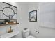 Stylish half bathroom with modern vessel sink, brushed gold faucet, and square black-framed mirror at 240 W Juniper Ave # 1020, Gilbert, AZ 85233