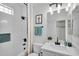 Updated bathroom features a shower with decorative curtain, white tile, and modern fixtures at 240 W Juniper Ave # 1020, Gilbert, AZ 85233