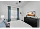Bright bedroom featuring a large window, dark dresser, and sleek ceiling fan at 240 W Juniper Ave # 1020, Gilbert, AZ 85233