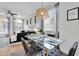 Dining area features a glass table, modern chairs, a woven light fixture and bright light at 240 W Juniper Ave # 1020, Gilbert, AZ 85233