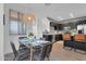Bright dining area features a modern glass table, stylish chairs, and a decorative pendant light at 240 W Juniper Ave # 1020, Gilbert, AZ 85233