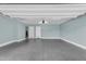 Spacious two-car garage featuring clean, light-blue painted walls and a sealed concrete floor at 240 W Juniper Ave # 1020, Gilbert, AZ 85233