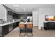 Well-equipped kitchen featuring stainless steel appliances, black cabinets, white countertops, and modern barstools at 240 W Juniper Ave # 1020, Gilbert, AZ 85233