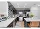 Modern kitchen boasts stainless steel appliances, black cabinetry, patterned backsplash, and white countertops at 240 W Juniper Ave # 1020, Gilbert, AZ 85233