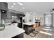 Stylish kitchen with stainless steel appliances, black cabinetry, white countertop island, and a patterned backsplash at 240 W Juniper Ave # 1020, Gilbert, AZ 85233