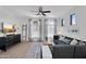 Inviting living room with a cozy sectional sofa, ceiling fan, and bright natural light at 240 W Juniper Ave # 1020, Gilbert, AZ 85233