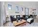 Bright and modern living room with a cozy gray sectional sofa, stylish decor, and dining area at 240 W Juniper Ave # 1020, Gilbert, AZ 85233
