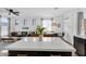 Bright living space features an open floor plan with kitchen island, dining area, and living room at 240 W Juniper Ave # 1020, Gilbert, AZ 85233