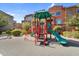 Community playground with colorful play structures nestled amongst landscaped residential buildings and walkways at 240 W Juniper Ave # 1020, Gilbert, AZ 85233