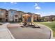 Community playground with slides and play structures in front of modern townhomes on a bright, sunny day at 240 W Juniper Ave # 1020, Gilbert, AZ 85233