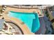 An overhead shot of a uniquely shaped pool surrounded by a secure fence and lounge chairs at 240 W Juniper Ave # 1020, Gilbert, AZ 85233