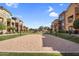 Sand volleyball court nestled in a manicured lawn, surrounded by residential buildings with mature landscaping at 240 W Juniper Ave # 1020, Gilbert, AZ 85233