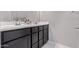 Bathroom vanity with double sinks, dark cabinets, and a white countertop at 2625 S Peppertree Dr # 101, Gilbert, AZ 85295