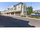 View of a townhome featuring multi-car garage, tan stucco and a tile roof at 2625 S Peppertree Dr # 101, Gilbert, AZ 85295