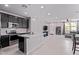 Open concept kitchen with stainless appliances and a white island connected to the living area at 2625 S Peppertree Dr # 101, Gilbert, AZ 85295
