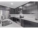 A well-appointed kitchen with dark wood cabinetry, stainless appliances and quartz countertops at 2625 S Peppertree Dr # 101, Gilbert, AZ 85295