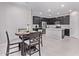 Modern kitchen with stainless steel appliances, dark cabinetry, and a central island at 2625 S Peppertree Dr # 101, Gilbert, AZ 85295