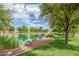 Scenic pond with a bridge, rocks, and lush green grass at 2625 S Peppertree Dr # 101, Gilbert, AZ 85295