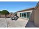 Inviting outdoor patio with a seating area, beautiful tile flooring, and lush landscaping at 26647 N 43Rd N St, Cave Creek, AZ 85331