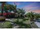 Lush backyard with stone pathway, colorful flowers, desert landscaping, and hammock seat at 26647 N 43Rd N St, Cave Creek, AZ 85331