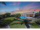 Expansive backyard with pool, patio, lush landscaping, and beautiful desert sunset at 26647 N 43Rd N St, Cave Creek, AZ 85331
