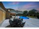 Outdoor dining area with large umbrella and pool in landscaped backyard with basketball hoop at 26647 N 43Rd N St, Cave Creek, AZ 85331
