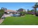 Backyard featuring a swimming pool, patio, well-maintained lawn, mature trees, and a basketball court at 26647 N 43Rd N St, Cave Creek, AZ 85331