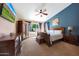 Spacious bedroom featuring a ceiling fan, tv and a blue accent wall at 26647 N 43Rd N St, Cave Creek, AZ 85331