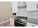 Modern kitchen with stainless steel appliances, white cabinetry, and stylish backsplash at 26647 N 43Rd N St, Cave Creek, AZ 85331