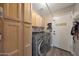 Laundry room with front loading washer and dryer, storage and access to outside at 26647 N 43Rd N St, Cave Creek, AZ 85331