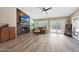 Cozy living area with a fireplace, decorative wood paneling, and sliding door access to the outdoor pool at 26647 N 43Rd N St, Cave Creek, AZ 85331