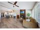 Open floor plan features hardwood floors, stone fireplace, kitchen with island, and living space at 26647 N 43Rd N St, Cave Creek, AZ 85331