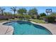 Sparkling pool with a volleyball net and lush landscaping, perfect for outdoor enjoyment at 26647 N 43Rd N St, Cave Creek, AZ 85331