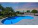Backyard swimming pool with volleyball net, basketball hoop, desert landscaping, and sunny sky at 26647 N 43Rd N St, Cave Creek, AZ 85331