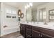 Bright bathroom featuring a dual sink vanity, soaking tub, framed art and a window at 2747 S 85Th Way, Mesa, AZ 85209