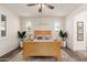 Bright bedroom featuring a ceiling fan, wood-look floors, natural light, and stylish furnishings at 2747 S 85Th Way, Mesa, AZ 85209