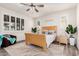 Bright bedroom featuring a ceiling fan, wood-look floors, natural light, and stylish furnishings at 2747 S 85Th Way, Mesa, AZ 85209