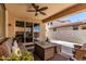 A stylish covered patio with comfortable seating and a ceiling fan, perfect for outdoor relaxation at 2747 S 85Th Way, Mesa, AZ 85209