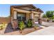 Inviting exterior with a charming front porch, desert landscaping, and a well-manicured lawn at 2747 S 85Th Way, Mesa, AZ 85209