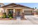 Charming single-story home featuring a decorative front door and well-maintained desert landscaping at 2747 S 85Th Way, Mesa, AZ 85209