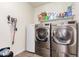 Bright laundry room features stainless steel washer and dryer units, and a mini fridge at 2747 S 85Th Way, Mesa, AZ 85209