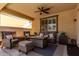 Inviting covered patio with comfortable seating, ceiling fan, and shade awning for relaxing outdoors at 2747 S 85Th Way, Mesa, AZ 85209