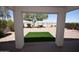 View from covered patio to backyard featuring desert landscaping and artifical turf at 28377 N Desert Native St, San Tan Valley, AZ 85143
