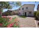 Spacious backyard features decorative rock landscaping, artificial turf, and covered patio at 28377 N Desert Native St, San Tan Valley, AZ 85143