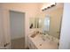 Bathroom featuring neutral tones, quartz countertops, framed mirror, and plenty of lighting at 28377 N Desert Native St, San Tan Valley, AZ 85143