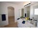 Bathroom featuring dual sinks and a doorway to the bedroom at 28377 N Desert Native St, San Tan Valley, AZ 85143