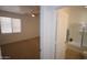 View into bedroom reveals neutral carpet and a doorway to an ensuite bathroom with a tub shower at 28377 N Desert Native St, San Tan Valley, AZ 85143