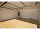 Spacious garage with epoxy flooring features water heater, lighting, and service door at 28377 N Desert Native St, San Tan Valley, AZ 85143