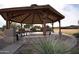 Community gazebo has an open-air design, providing a shaded space with picnic tables for residents to gather and relax at 28377 N Desert Native St, San Tan Valley, AZ 85143