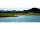 Scenic lake on golf course with lush green surroundings and mountain views, adding to the community's recreational appeal at 28377 N Desert Native St, San Tan Valley, AZ 85143